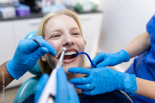 Teeth health concept. Cropped photo of smiling woman mouth under treatment at dental clinic