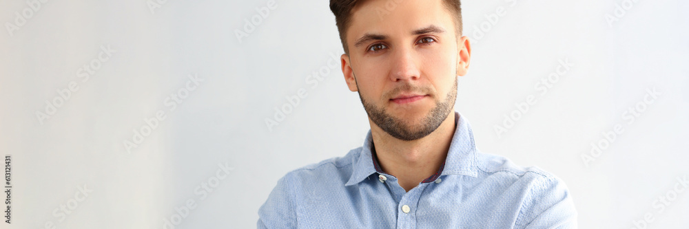 Obraz premium Portrait of handsome young business man posing for camera. Smart attractive guy employee consultant manager in blue shirt