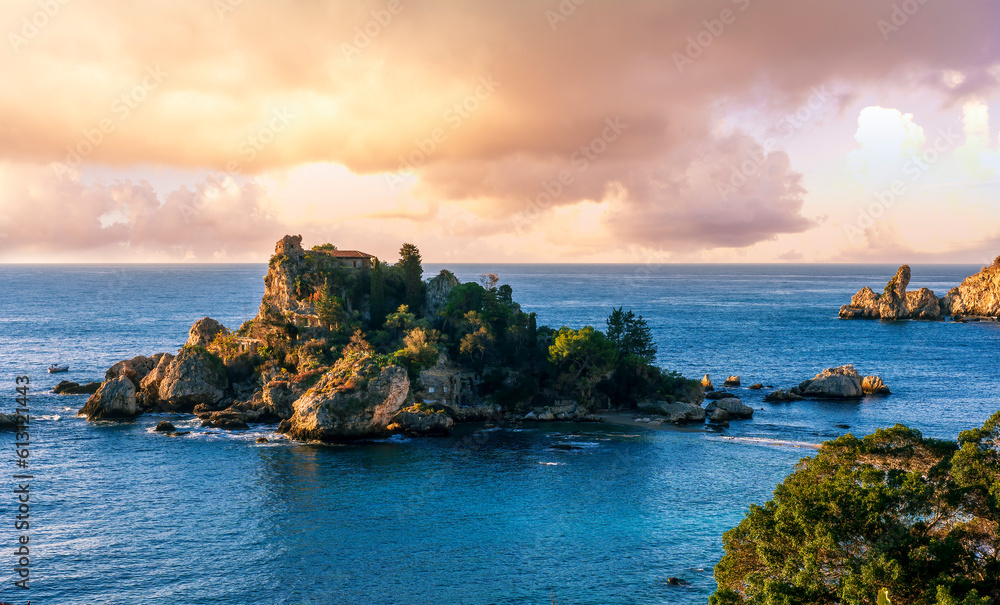 scenic sea shore view of island in ocean with waves and amazing cloudy sunset or sunrise on backgeound