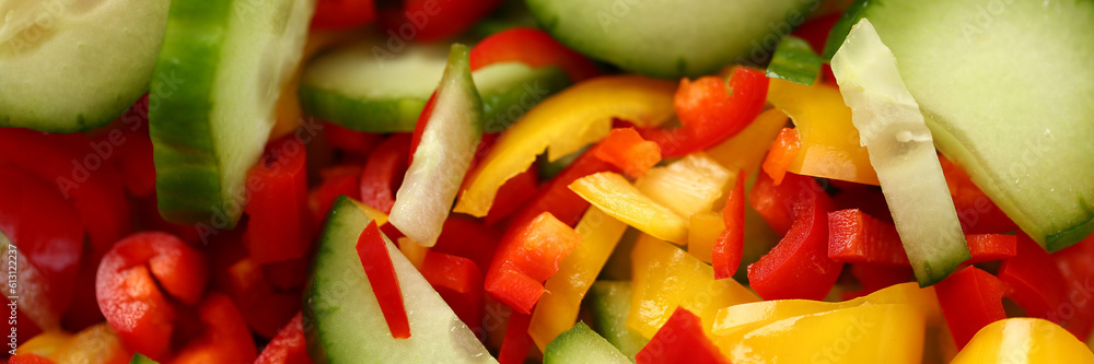 Fresh vegetables cucumbers red yellow peppers sliced in salad. Benefits of vegetarian food concept Fresh vegetables cucumbers red yellow peppers sliced in salad. Benefits of vegetarian food concept