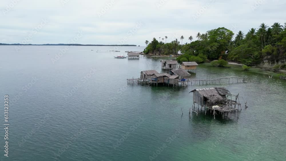 Aerial dolly above ramshackle fishing village huts in water off balabac island Aerial dolly above ramshackle fishing village huts in water off balabac island