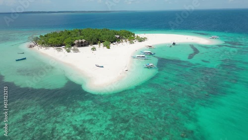 Patawan Island aerial panoramic overview of bungalow, banca boat, and tourists photo