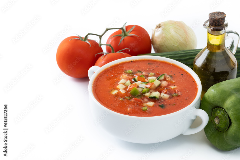 Traditional Spanish gazpacho soup in bowl with ingredients isolated on white background. Copy space Traditional Spanish gazpacho soup in bowl with ingredients isolated on white background. Copy space