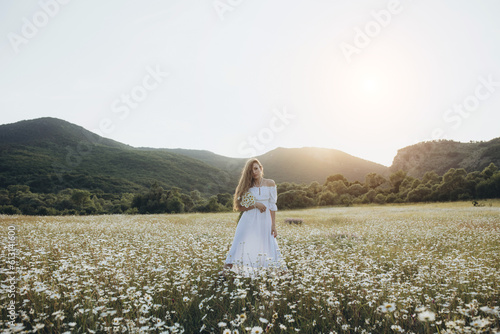 Beautiful woman in nature with flowers.