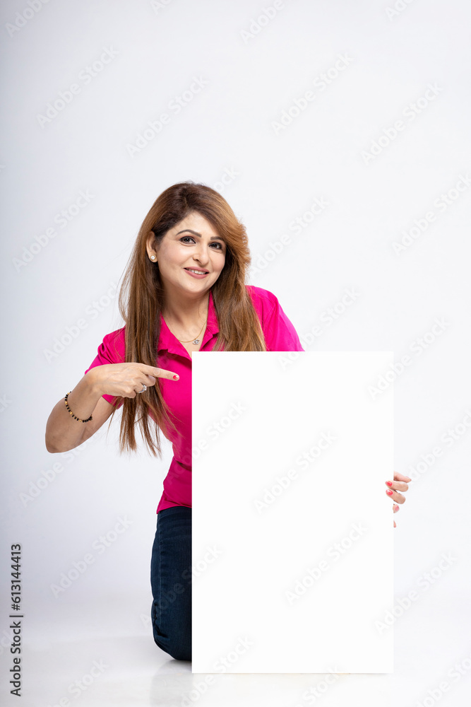 Indian woman showing blank white board on white background Indian woman showing blank white board on white background