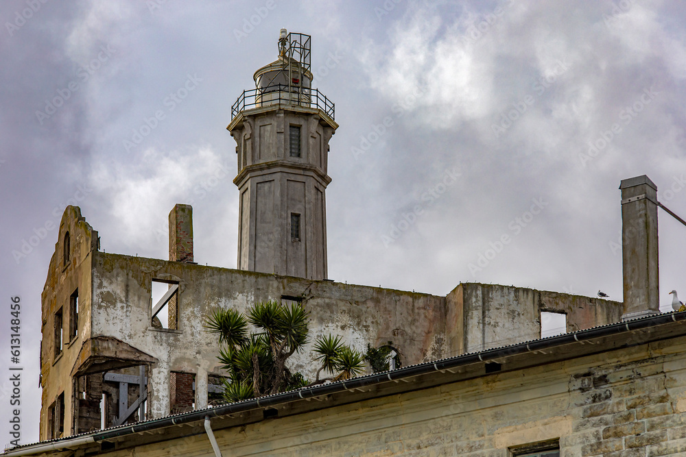 Sally Harbor and guardhouse with watchtower of the U.S. federal prison on Alcatraz Island in San Francisco Bay, California, USA. Surveillance under a cloudy sky. Jail concept.