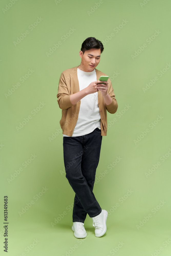 image of young Asian man on green background image of young Asian man on green background
