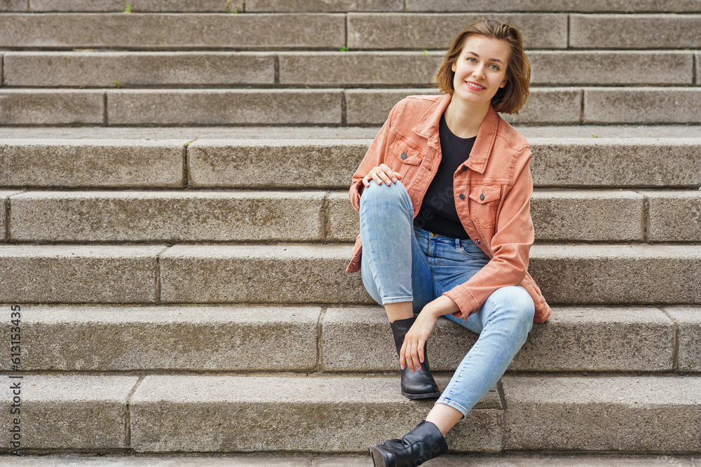 Young woman sitting on stairs in the city Young woman sitting on stairs in the city