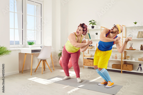 Two funny people enjoying sports workout at home. Happy fat woman dancing together with personal fitness trainer. Cheerful family couple add physical activity in life and do aerobics exercise to music