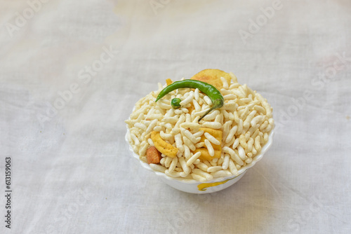 Top view of Murmura spicy puffed rice, Jhal Muri, Borugulu and green chilli, in Kolkata, West Bengal, India. is a traditional home made Vegan mid-morning snack or cereal breakfast, Indian street food.