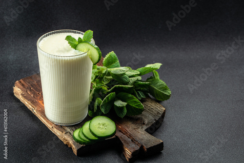 Ayran or Doogh is a popular refreshing yogurt on a dark background. Restaurant menu, dieting, cookbook recipe top view photo