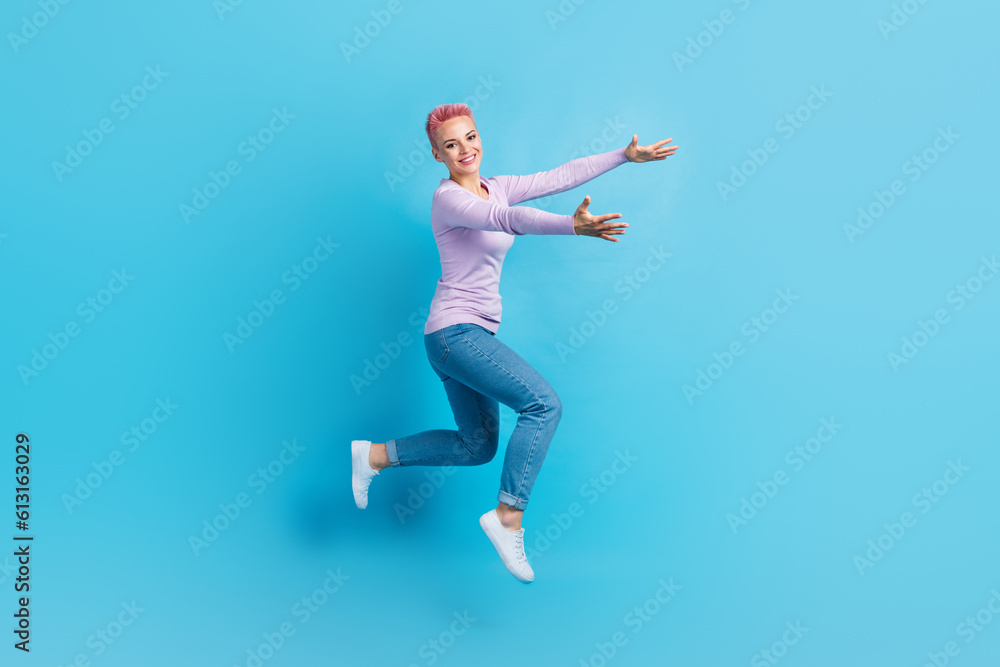 Full length photo of young girl pink dyed hair wear denim jeans purple shirt hugs embrace empty space isolated on blue color background
