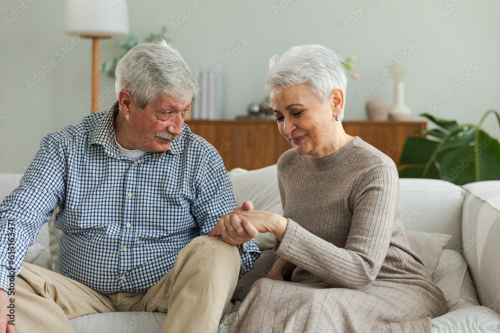 Senior adult mature couple in love holding hands at home. Mid age old husband and wife looking with tenderness love enjoying wellbeing. Grandmother grandfather together. Family moment love and care Senior adult mature couple in love holding hands at home. Mid age old husband and wife looking with tenderness love enjoying wellbeing. Grandmother grandfather together. Family moment love and care