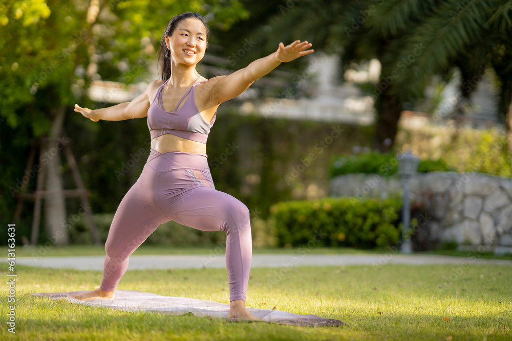 Asian woman wearing yoga clothes doing yoga at her village garden in the morning, happily, Sports healthy lifestyle concepts, Japanese concepts. Asian woman wearing yoga clothes doing yoga at her village garden in the morning, happily, Sports healthy lifestyle concepts, Japanese concepts.