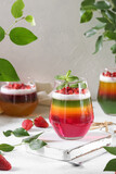 Summer berry jelly, layered and served with a mint leaf garnish.