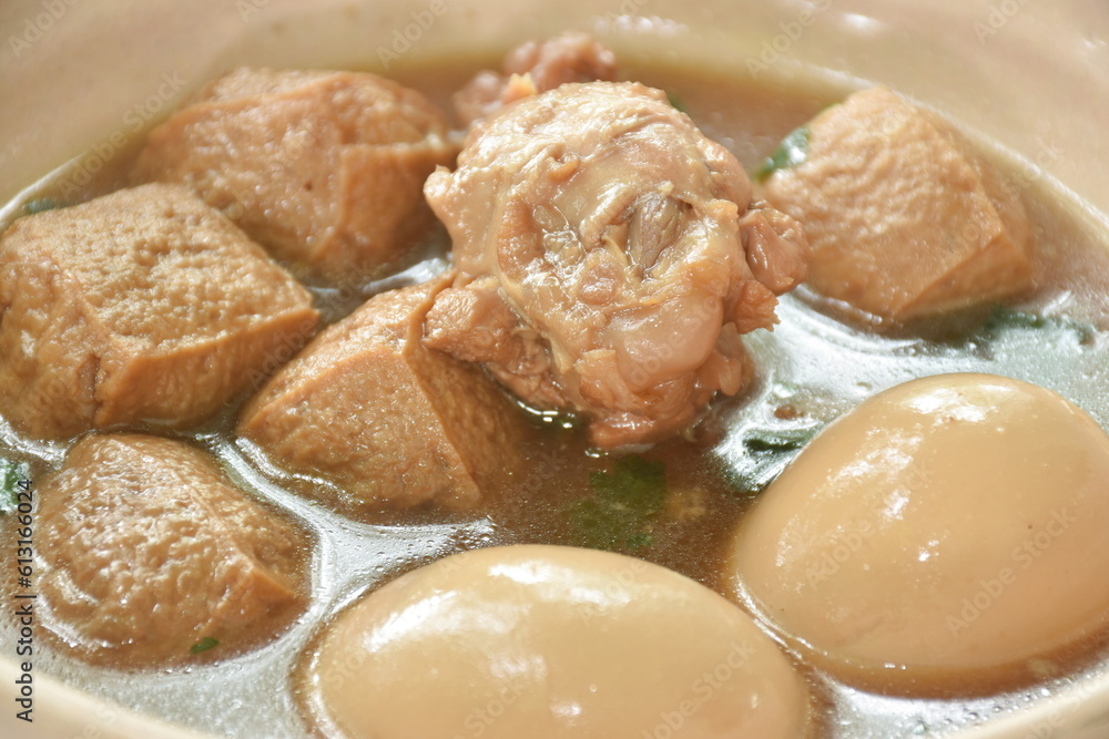 boiled egg with chicken drumstick with fried tofu in herb brown soup on bowl boiled egg with chicken drumstick with fried tofu in herb brown soup on bowl