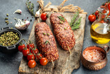 raw Lula kebab on skewers with spices, on a wooden background, Concept healthy and balanced eating. place for text, top view