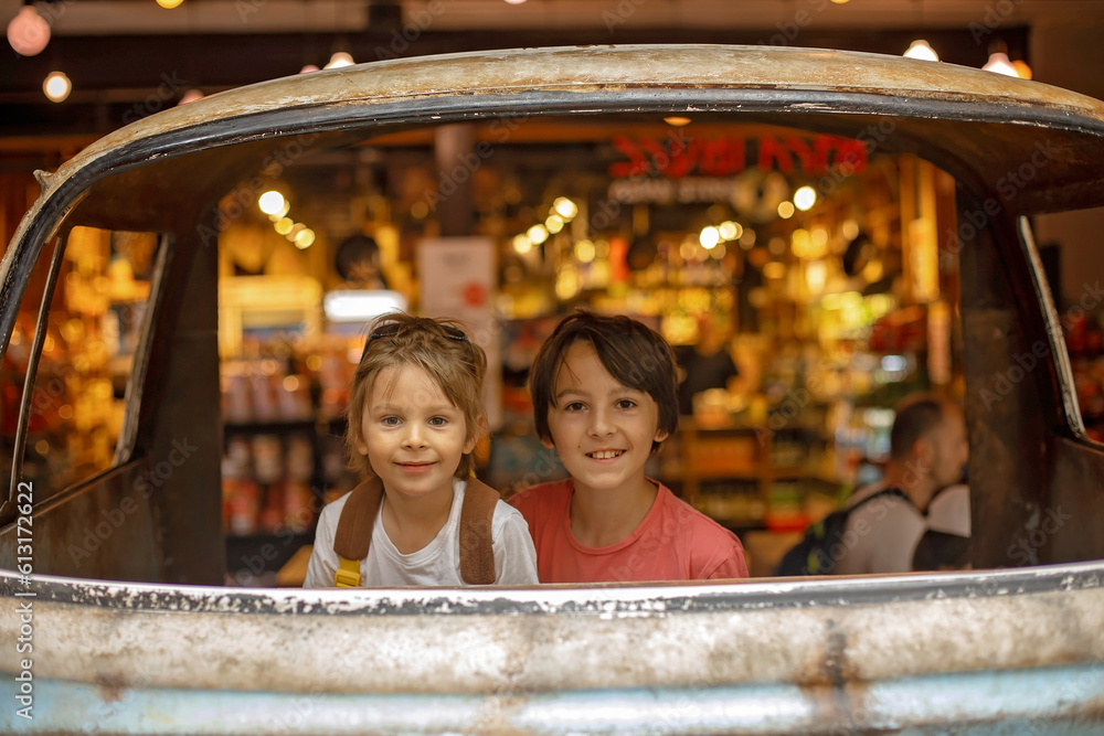 Family with kids, enjoying the Sarona Market in Tel Aviv, Israel