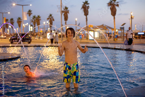 Cute child, boy, playing with water in fountain in Tel Aviv © Tomsickova