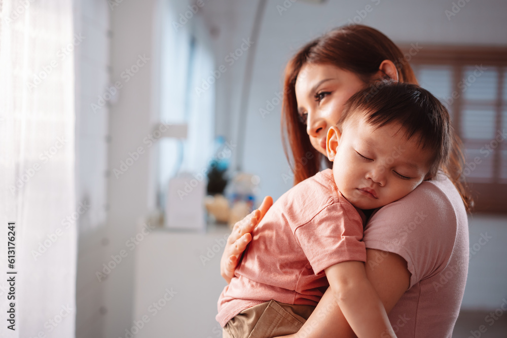 Happy asian mother carrying her baby son. parent supporting little boy at home. Happy asian mother carrying her baby son. parent supporting little boy at home.