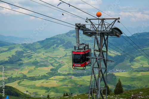 Large red funicular cabin taking tourists up the mountain in the Swiss Alps