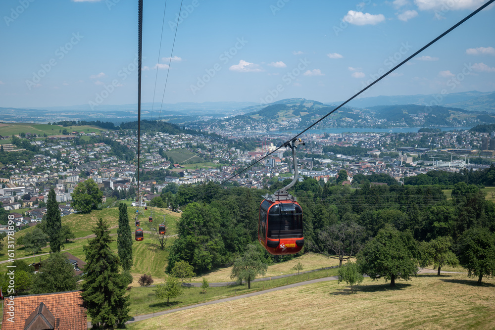 Large red funicular cabin taking tourists up the mountain in the Swiss Alps