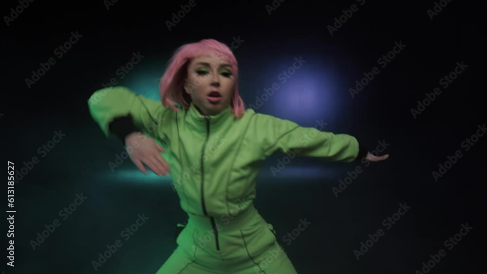 Girl dancer dancing hip hop. Young Girl Moves Rhythmically. Lighting Creates Blue And Green Colors Girl dancer dancing hip hop. Young Girl Moves Rhythmically. Lighting Creates Blue And Green Colors
