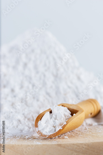 Tapioca starch powder in a wooden scoop.