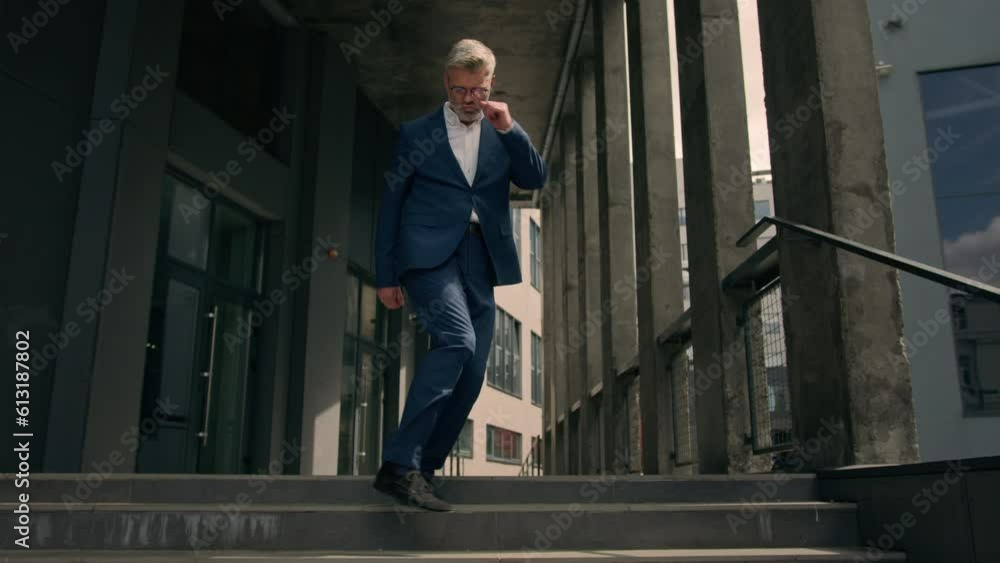 Funny moving happy Caucasian senior business worker employee mature man businessman dancing walking on stairs near office building outdoors walk dance celebrate achievement having fun fooling around Funny moving happy Caucasian senior business worker employee mature man businessman dancing walking on stairs near office building outdoors walk dance celebrate achievement having fun fooling around