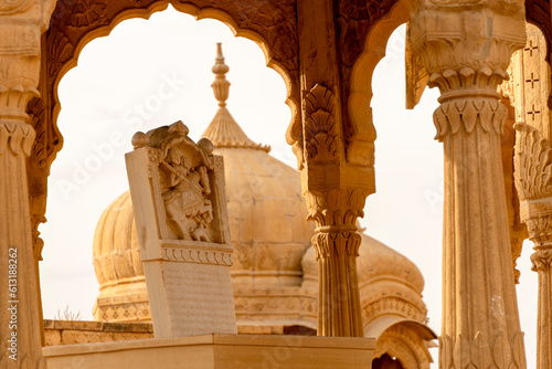 The royal cenotaphs of historic rulers, also known as Jaisalmer Chhatris, at Bada Bagh in Jaisalmer, Rajasthan, India. Cenotaphs made of yellow sandstone photo