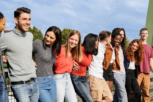 Multiracial group of people having fun outdoors - Young friends laughing together outdoor in summer day - Focus on african bald girl face