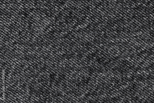 Texture of denim fabric in black color close-up.