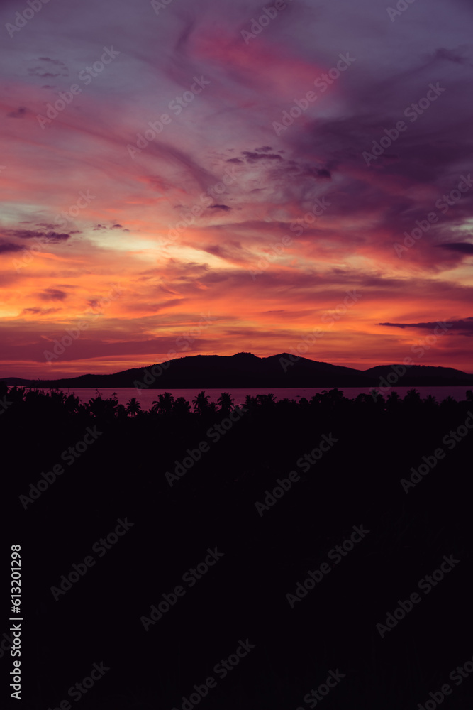 Amazing sunset in Puerto Princesa, Palawan, with flaming red sky, sea and other islands of the archipelago in the background.