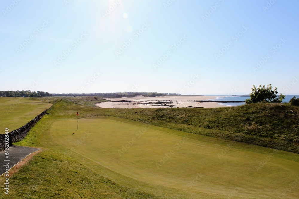 An incredible view of a golf hole in Scotland with the ocean in the background in North Berwick, East Lothian, Scotland An incredible view of a golf hole in Scotland with the ocean in the background in North Berwick, East Lothian, Scotland