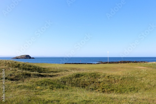 An incredible view of a golf hole in Scotland with the ocean in the background in North Berwick  East Lothian  Scotland