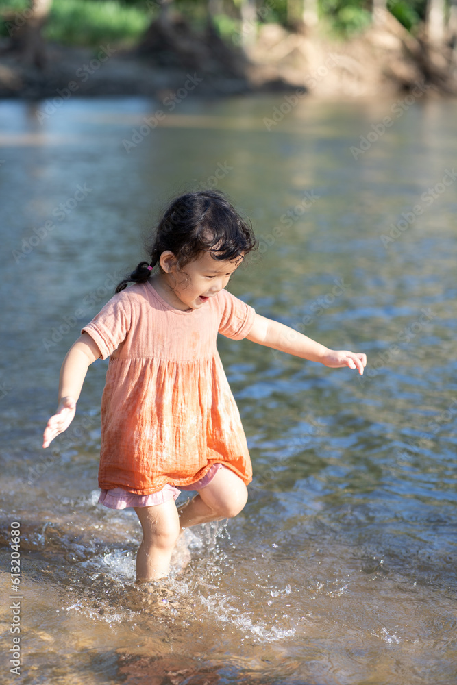 little child playing on water stream little child playing on water stream