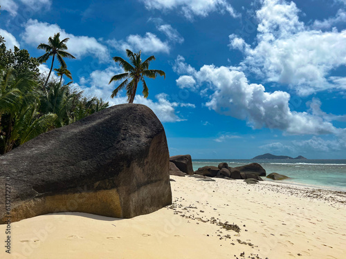 Typical beach with granite rocks and palms in Seychelles