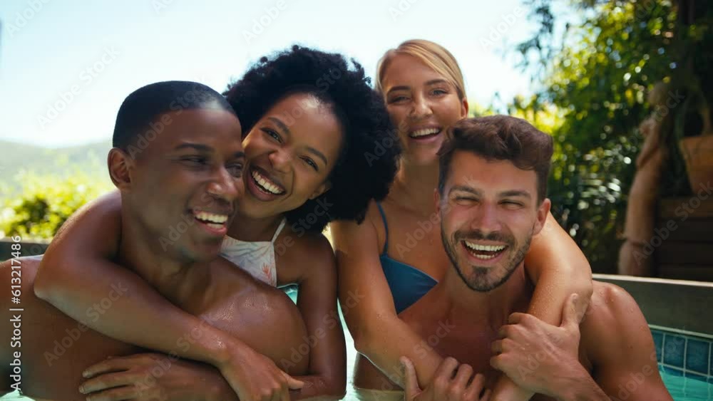 Smiling group of friends on holiday in swimming pool with men giving women piggyback rides - shot in slow motion Smiling group of friends on holiday in swimming pool with men giving women piggyback rides - shot in slow motion