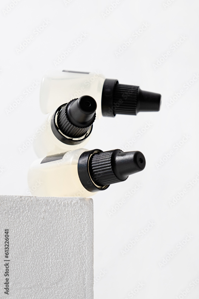 Set of plastic dropper bottles with liquid with black blank stickers. Mockup Set of plastic dropper bottles with liquid with black blank stickers. Mockup