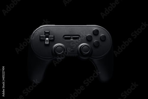 Black video game controller on black background. Wireless joystick tech, Online games, console setup. Nerdy youth, challenges, screen time. Time for entertainment, play, fun. 