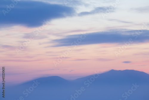 View of the snow-capped mountains at sunset. Winter arctic landscape. Cold winter weather. Frosty fog over the tundra. Picturesque arctic nature. Mount Dionysius, Chukotka, Siberia, Far North Russia. © Andrei Stepanov