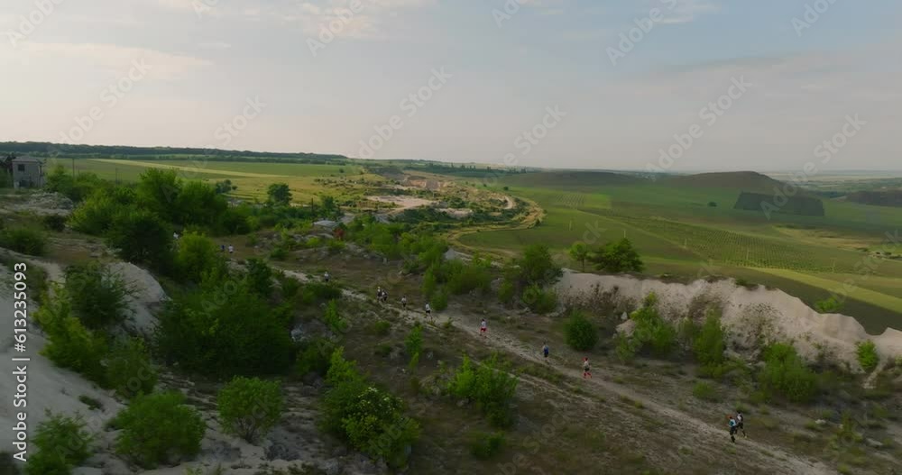 aerial view of group of people running in limestone quarry in fetesti during sunrise aerial view of group of people running in limestone quarry in fetesti during sunrise