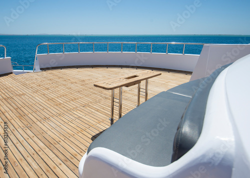 Table and chairs on bow deck of a luxury motor yacht © Paul Vinten