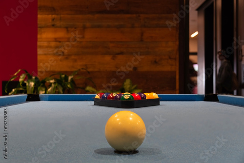 Billiard pool table with colorful balls on it.