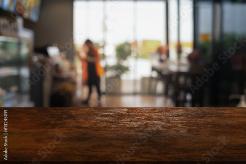 wooden table top with lights bokeh on blur restaurant background.
