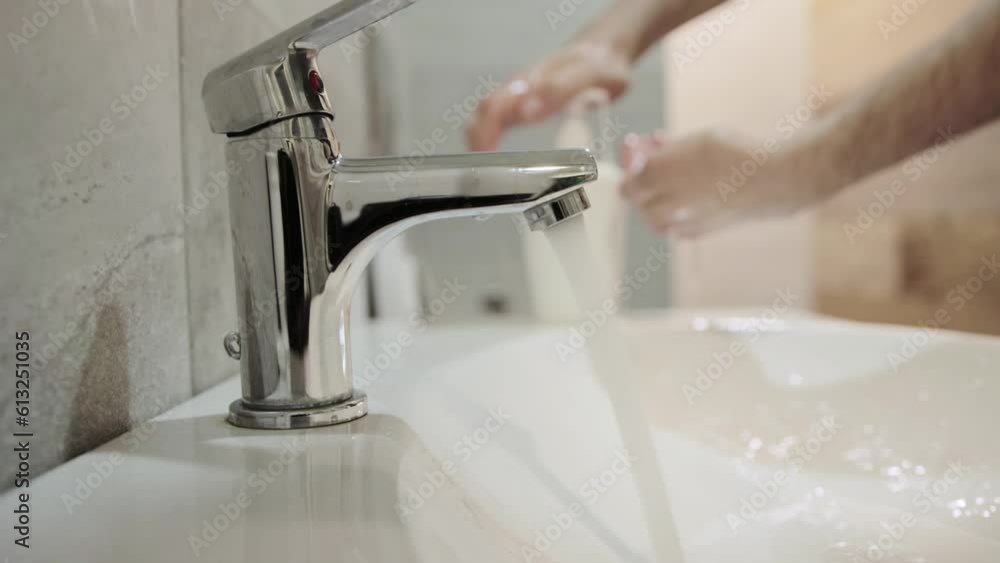 Washing hands with soap in a public toilet. Hand hygiene, protection against infections and bacteria, close-up Washing hands with soap in a public toilet. Hand hygiene, protection against infections and bacteria, close-up