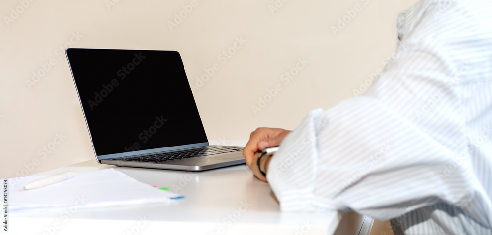 Laptop with blank screen on the desk in front of business person, computer networking, online meeting, video call, web conference, corporate virtual communication. Laptop with blank screen on the desk in front of business person, computer networking, online meeting, video call, web conference, corporate virtual communication.