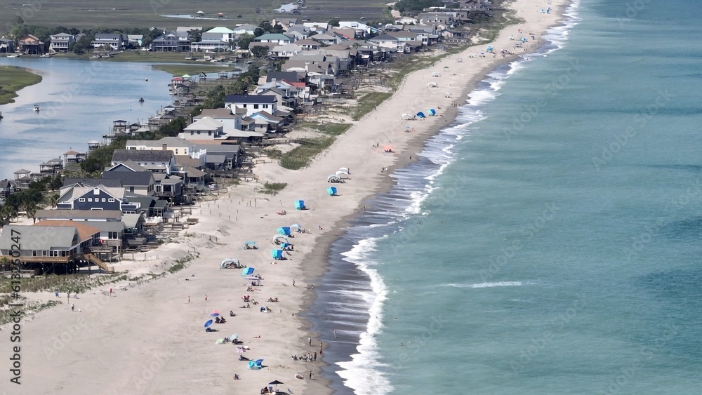 Enjoying sunny day at the beach by the ocean with people sun bathing at Pawleys Island, SC north of Myrtle Beach on the Grand Strand in the South Carolina Low Country a vacation destination Enjoying sunny day at the beach by the ocean with people sun bathing at Pawleys Island, SC north of Myrtle Beach on the Grand Strand in the South Carolina Low Country a vacation destination