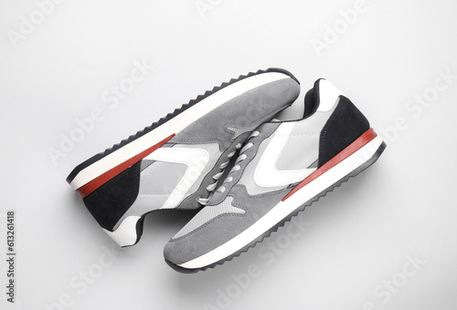 Gray running shoes on gray background. Casual sneakers. Top view