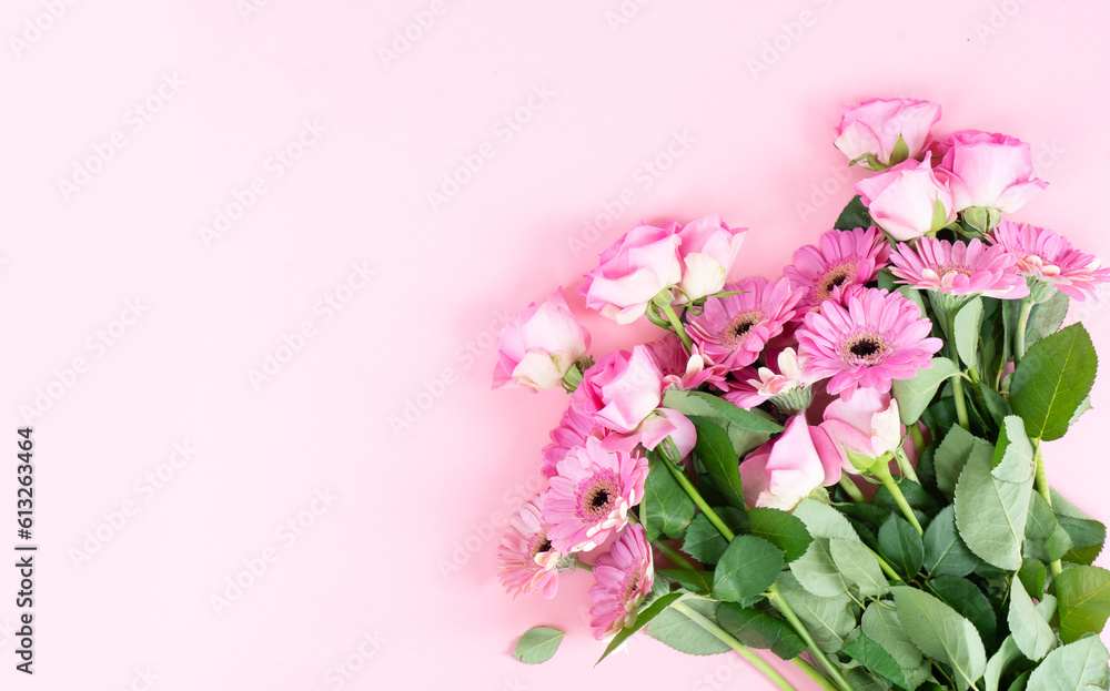 wedding or mothers day background, bouquet of roses and herberas over plain pink background wedding or mothers day background, bouquet of roses and herberas over plain pink background